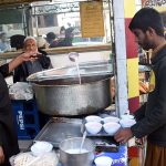 A shopkeeper serves pink tea to customers as demand rises with the onset of winter