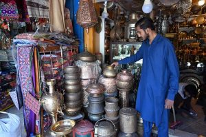 A vendor preparing flower garlands for customers at F-6 area in the Federal Capital