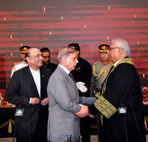 Prime Minister Muhammad Shehbaz Sharif shaking hands with Justice Aminuddin Khan at his oath taking ceremony at Aiwan-e-Sadr.