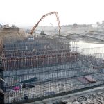 Labourers busy in reconstruction work of the M5 Motorway after being damaged by flooding while heavy machinery and workers reinforce the structure at the site at Jalalpur Pirwala.