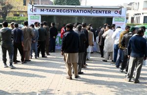 “People stand in a queue to install E-tags/M-tags for their vehicles at Kachnar Park