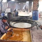 A labourer prepares jaggery from sugarcane at his workplace along Mirpurkhas Road