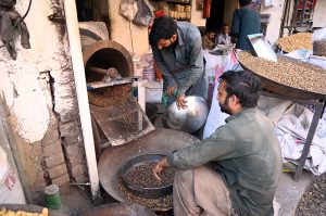 A worker busy polishing brass items at his workplace to attract customers at Bhabra Bazaar area in the city