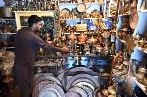 A vendor preparing flower garlands for customers at F-6 area in the Federal Capital