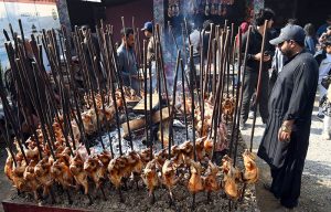 A vendor preparing tradition sajji to attract customers during the ten-day annual folk festival “Lok Mela 2025” at Lok Virsa.