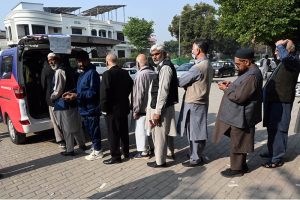 “People stand in a queue to install E-tags/M-tags for their vehicles at Kachnar Park