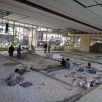 Laborers work on preparing a play area beneath the Sixth Road flyover