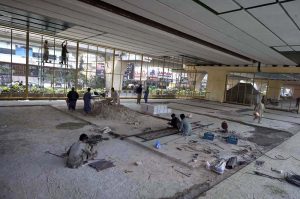 Laborers work on preparing a play area beneath the Sixth Road flyover