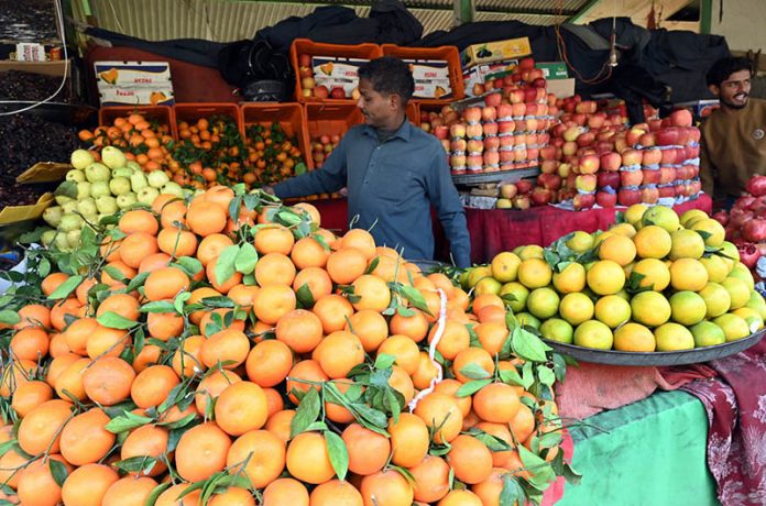 A vendor selling fruits in weekly bazar at Peshawar morr in the Federal Capital