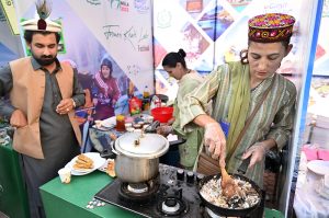 Entrepreneurs selling traditional food at a stall at Ten-Day annual folk festival “Lok Mela 2025” at Lok Virsa