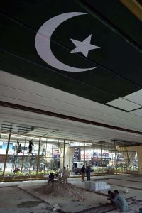 Laborers work on preparing a play area beneath the Sixth Road flyover