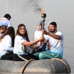 Olympian Sadaf Siddiqui, along with other participants, holds the torch during the 35th National Games Torch Relay ceremony at Rawal Lake, Islamabad, organized by the Islamabad Olympic Association