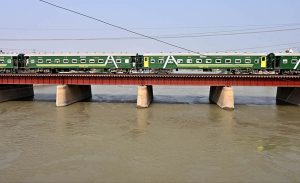 A beautiful view of train passing over a bridge on the water canal at Tando Yousuf area.