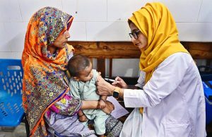 A lady doctor administers a vaccine to a child at Shah Bhitai Hospital during the National Measles and Rubella Prevention Campaign underway in the city