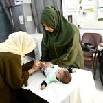 A lady health worker administers vaccine to a child at C.D.F Hospital during the National Measles and Rubella Prevention Campaign underway in the city
