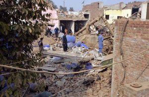 Rescue 1122 personnel remove debris from nearby houses that collapsed after a gas-boiler explosion in a chemical factory near Chak No. 203-RB Malik Pur, which caused multiple deaths and left several others injured