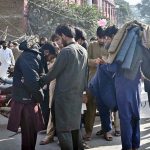 People are buying jackets from vendors in a local market of Provincial Capital.