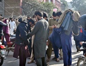 People are buying jackets from vendors in a local market of Provincial Capital.