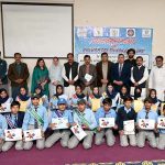 A view of group photo of Deputy Director National Commission for Human Development Umar Daraz Jhawari and others along with students during the ceremony titled 'World Children Day 2025' jointly organised by Child Protection and Welfare Bureau and National Commission for Human Development at DPS School