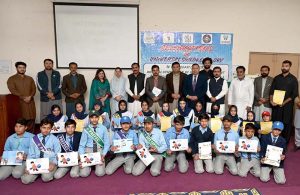 A view of group photo of Deputy Director National Commission for Human Development Umar Daraz Jhawari and others along with students during the ceremony titled 'World Children Day 2025' jointly organised by Child Protection and Welfare Bureau and National Commission for Human Development at DPS School