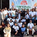 Participants pose for a group photo during the 35th National Games Torch Relay ceremony at Rawal Lake, Islamabad, organized by the Islamabad Olympic Association