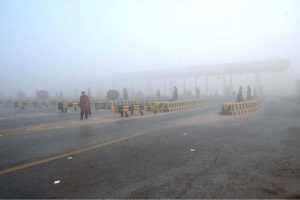 A view of thick fog engulfs the city, leading to the closure of the motorway.