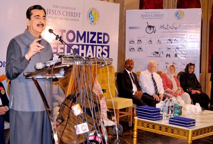 Acting President/Chairman Senate, Syed Yousaf Raza Gillani addressing a customized wheelchair distribution ceremony jointly organized by the Church of Jesus Christ of Latter day Saints and Society for Special Persons