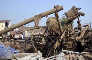 Rescue 1122 personnel remove debris from nearby houses that collapsed after a gas-boiler explosion in a chemical factory near Chak No. 203-RB Malik Pur, which caused multiple deaths and left several others injured