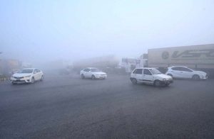 A view of thick fog engulfs the city, leading to the closure of the motorway.