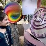 A girl visits a stall at the Ten-Day annual folk festival “Lok Mela 2025” at Lok Virsa