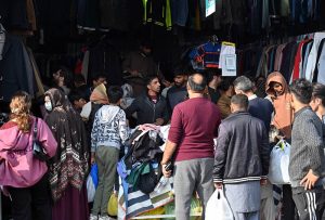 Women select and purchase clothes at the G-9 weekly bazaar in the Federal Capital