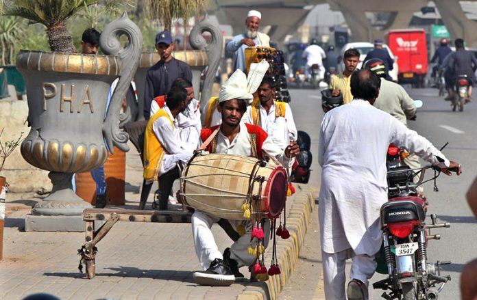 Traditional drummers, who usually perform at wedding ceremonies, are waiting to be hired at their roadside setup