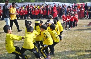 Secretary Workers Welfare Fund Zulfiqar Ahmad joins students holding torches to kick off the opening ceremony of Kaiynaat School System’s Annual Sports Gala 2025 at Sector I-10.