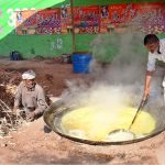 Farmers boil sugarcane juice to prepare jaggery "Gur" a popular winter treat, at their workplace