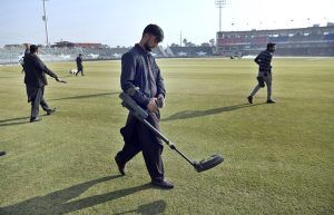 Security officials check the cricket ground and pitch with a metal detector before the start of the Pakistan vs Zimbabwe T20 Tri-Series match at Rawalpindi Cricket Stadium.