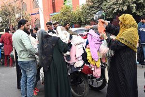 Families are busy in selecting and purchasing second hand warm clothes Landa market