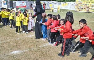 Secretary Workers Welfare Fund Zulfiqar Ahmad joins students holding torches to kick off the opening ceremony of Kaiynaat School System’s Annual Sports Gala 2025 at Sector I-10.