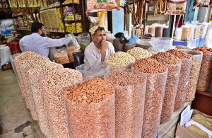 A vendor displaying dry fruits to attract the customers at his shop.