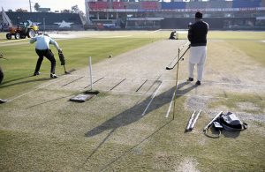 Security officials check the cricket ground and pitch with a metal detector before the start of the Pakistan vs Zimbabwe T20 Tri-Series match at Rawalpindi Cricket Stadium.