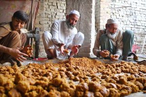 An elderly man prepares the traditional sweetener jaggery 'Gur' from sugarcane juice at Tang Koruna in the Charsadda area.