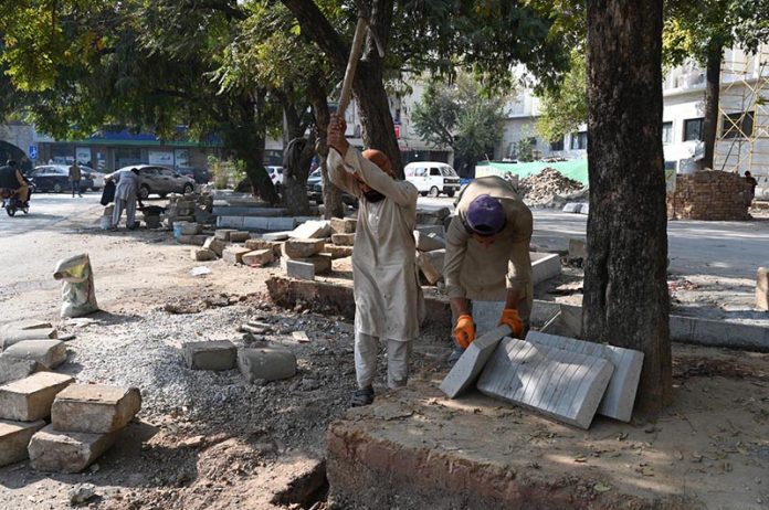 Labourers busy in construction work at Melody Food Street