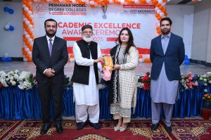 Executive Director strategy and Coordination City University Science & Information Technology Muhammad Ayoub Sethi presenting a shield to Secretary Mardan Board Prof. Hazrat Ali during Academic Excellence Award Ceremony 2025 of PMDC