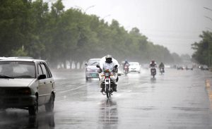 A family getting soak during the first rain of the season in the federal capital as temperatures started to drop