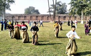 Children take part in a sack race as the Walled City of Lahore Authority, under the Punjab Government, hosts traditional Punjabi sports at the historic Khedan Lahore Dayan Ka Makbara Noor Jahan to preserve and promote the region’s cultural heritage