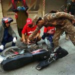 Rescue and security personnel collect evidence at the scene of a suicide attack on the Federal Constabulary headquarters, where three FC soldiers were killed and 11 civilians injured