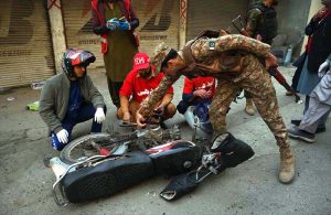 Rescue and security personnel collect evidence at the scene of a suicide attack on the Federal Constabulary headquarters, where three FC soldiers were killed and 11 civilians injured
