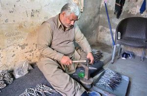 A skilled worker crafts export-quality surgical instruments at a private manufacturing unit, highlighting Sialkot’s global reputation in precision manufacturing.