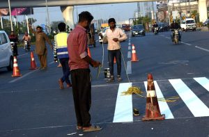NHA staff install a zebra crossing with a pedestrian-friendly barrier to ensure smooth traffic flow along Walton Road.