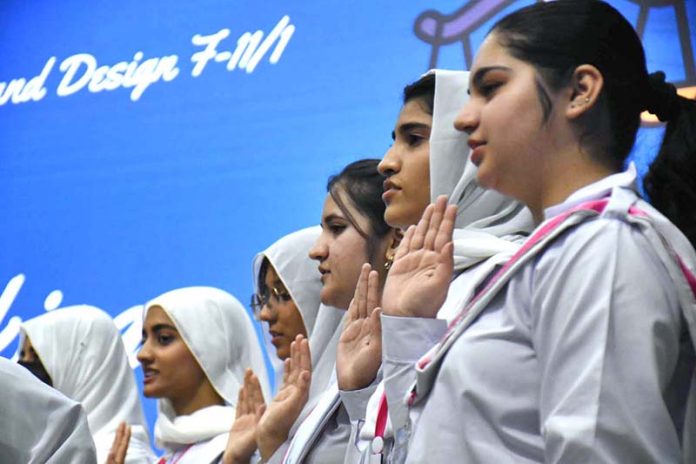 Members of Students Council taking oath in a ceremony at Institute of Home Economics, Art and Design College F-11/1
