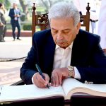 Federal Minister for National Food Security and Research Rana Tanveer Hussain recording his remarks in the visitor's book after laying floral wreaths to pay homage to the national poet Allama Muhammad Iqbal on his 148th birthday anniversary at Mazar-e-Iqbal